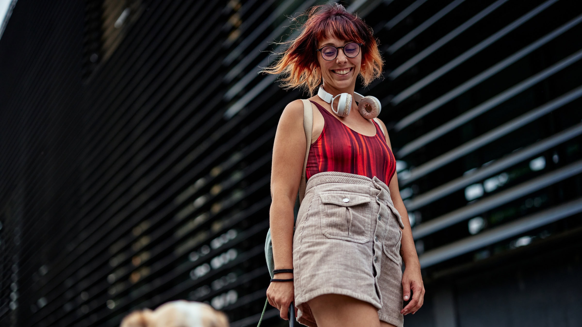 Woman skateboarding with her dog